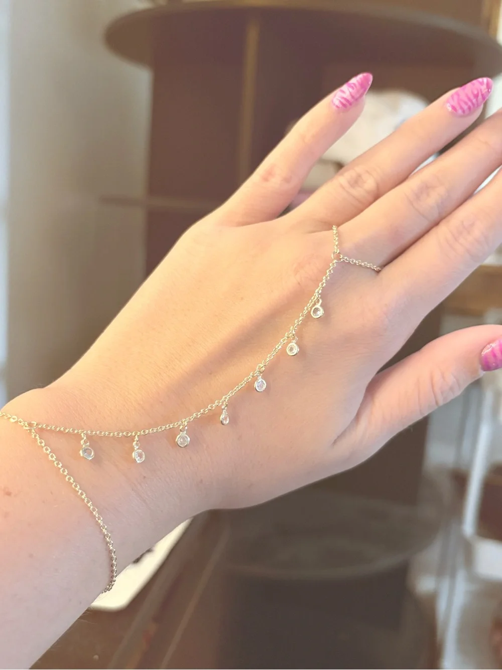 Altar'd State Gold Hand Chain with Dangle Charms and Pink Nails